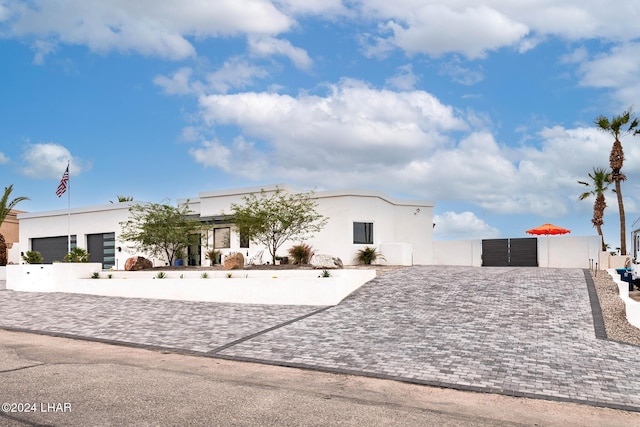 view of front facade featuring a gate and stucco siding