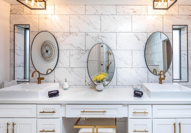 full bath featuring a sink, decorative backsplash, and double vanity