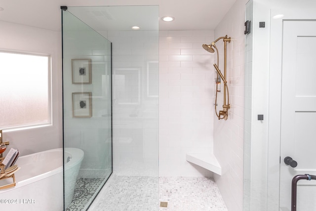 full bathroom with a soaking tub, recessed lighting, and tiled shower