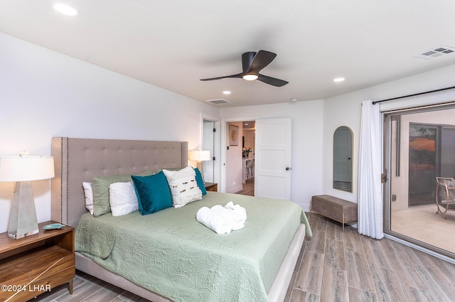 bedroom with access to exterior, recessed lighting, wood finished floors, and visible vents