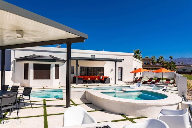 view of pool featuring a ceiling fan, a fenced in pool, an outdoor living space, an in ground hot tub, and a patio area