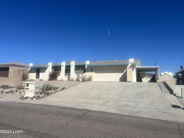 view of front of property featuring driveway, a garage, fence, a carport, and stucco siding