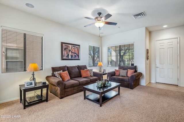 living room featuring ceiling fan, light tile patterned floors, recessed lighting, light carpet, and visible vents