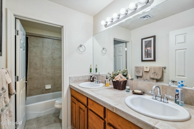 bathroom with visible vents, a sink, toilet, and tile patterned floors