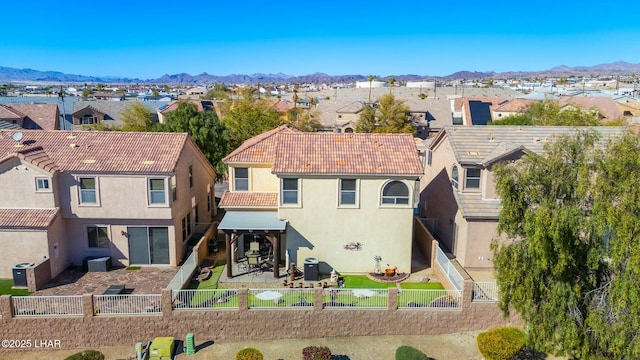 rear view of house featuring a fenced backyard and a residential view