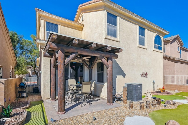 back of house with a patio, central AC, fence, a ceiling fan, and stucco siding