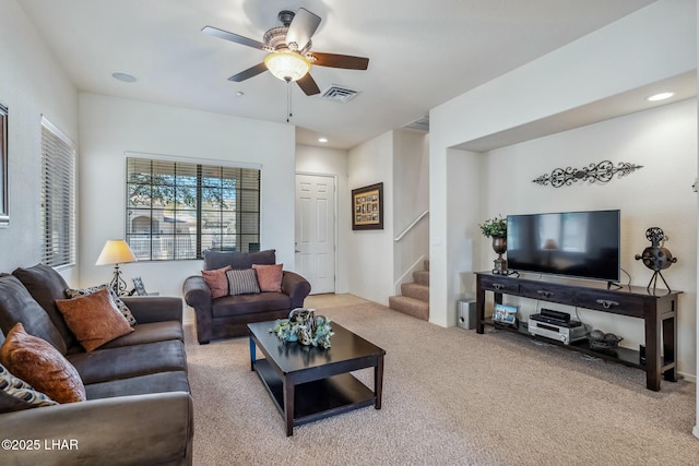 carpeted living room with stairway, visible vents, a ceiling fan, and recessed lighting