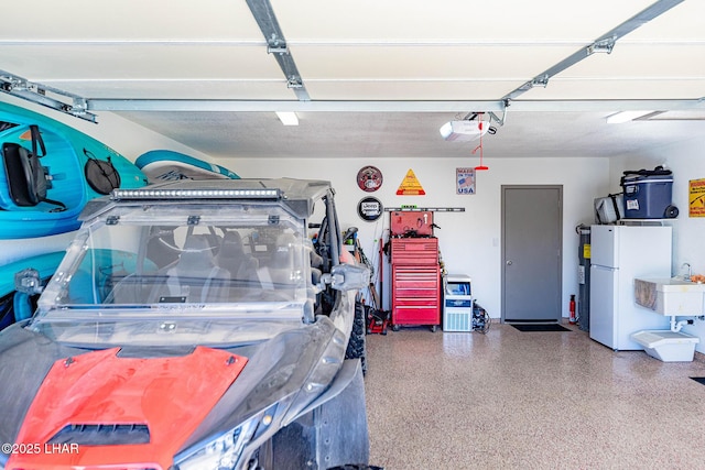 garage featuring a garage door opener and white fridge