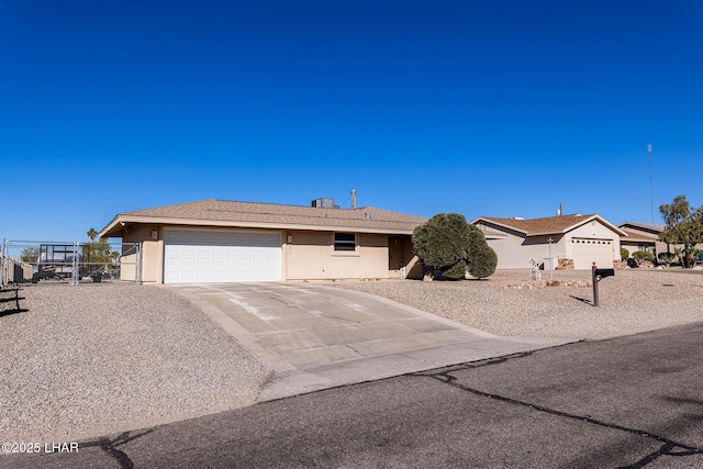 ranch-style home with cooling unit and a garage