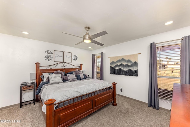 carpeted bedroom with multiple windows and ceiling fan