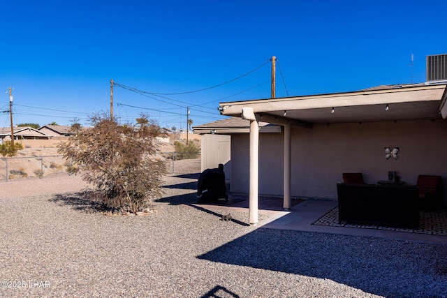 view of yard with cooling unit and a patio