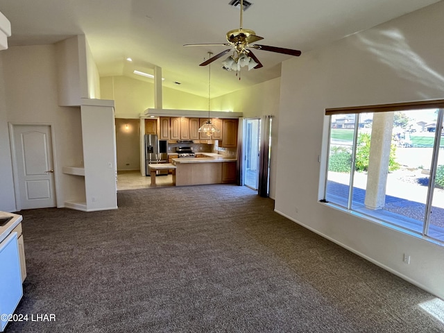 kitchen with ceiling fan, high vaulted ceiling, carpet, stainless steel fridge with ice dispenser, and kitchen peninsula