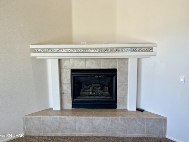 room details featuring a tile fireplace