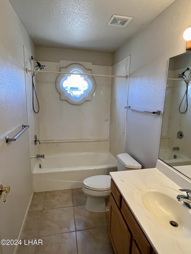 full bathroom featuring washtub / shower combination, toilet, a textured ceiling, vanity, and tile patterned flooring