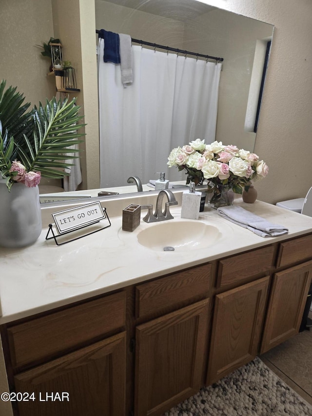 bathroom with vanity, tile patterned floors, toilet, and a shower with shower curtain