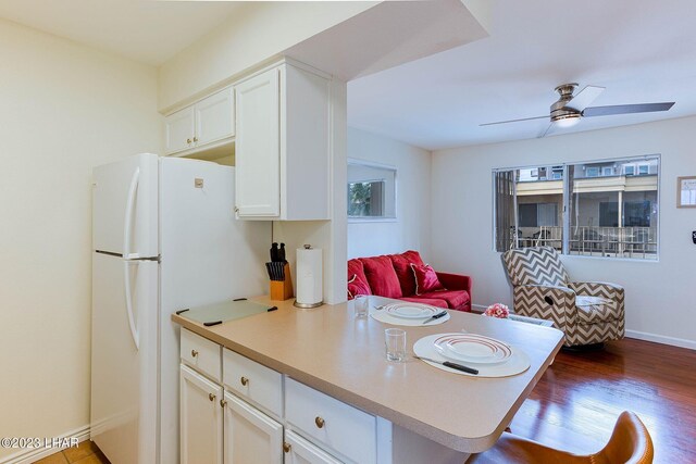 kitchen with white refrigerator, plenty of natural light, hardwood / wood-style flooring, and ceiling fan