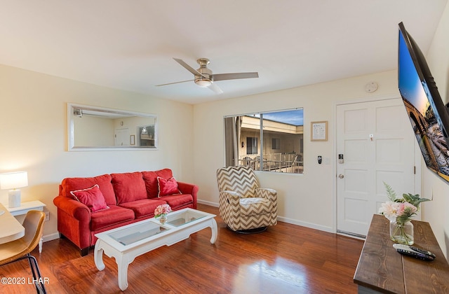 living room featuring dark hardwood / wood-style flooring and ceiling fan