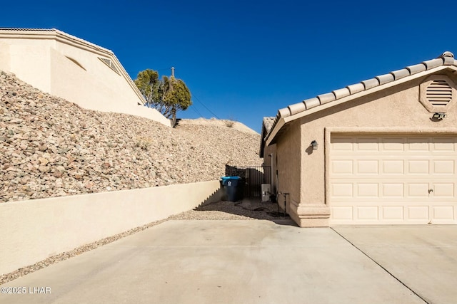 view of side of home featuring a garage