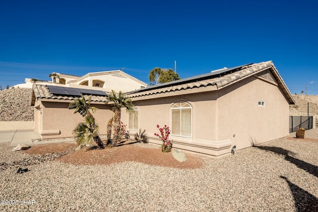 view of front of house featuring solar panels