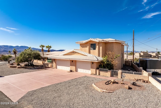 view of front of home with a mountain view and a garage