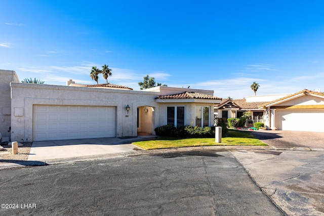 view of front of property with a garage and a front yard