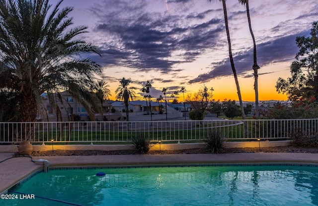 view of pool at dusk