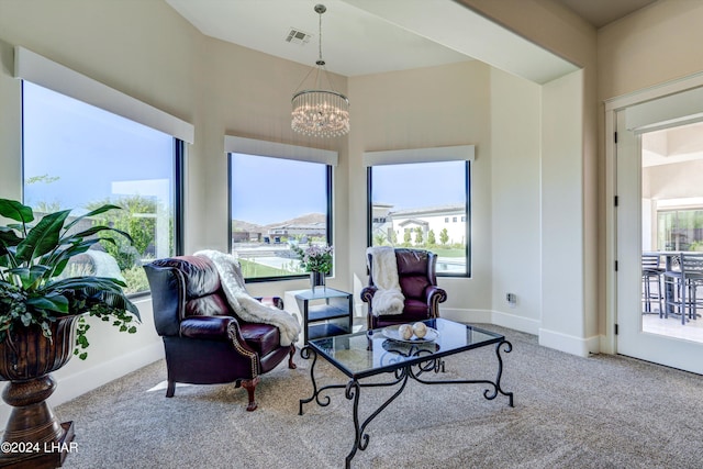 interior space featuring baseboards, visible vents, and a chandelier