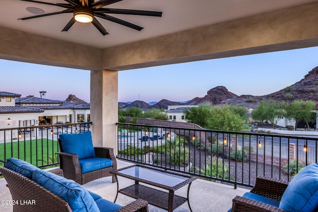 balcony featuring outdoor lounge area, a mountain view, and a ceiling fan