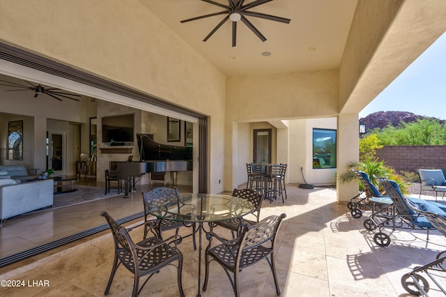 view of patio / terrace featuring ceiling fan, fence, and outdoor dining area