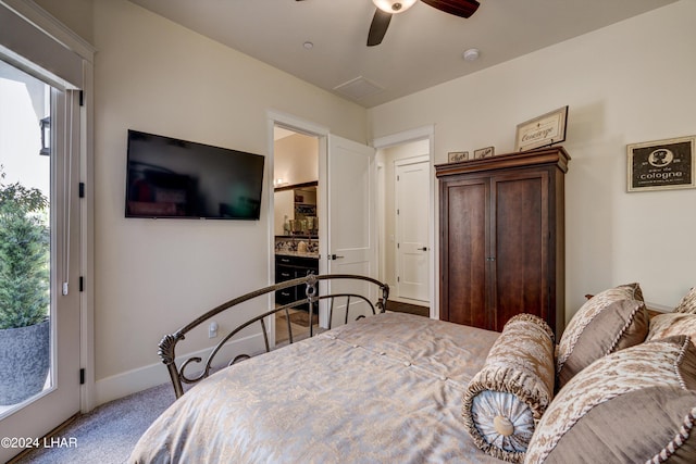 bedroom with ensuite bathroom, carpet flooring, visible vents, a ceiling fan, and baseboards