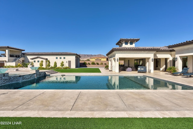 view of pool featuring a pool with connected hot tub and a patio