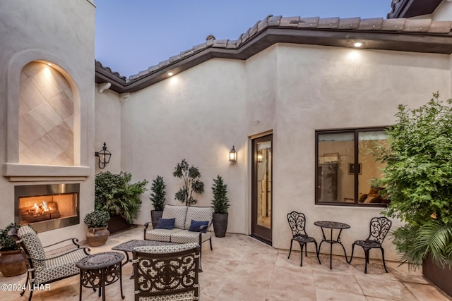 view of patio / terrace with an outdoor living space with a fireplace