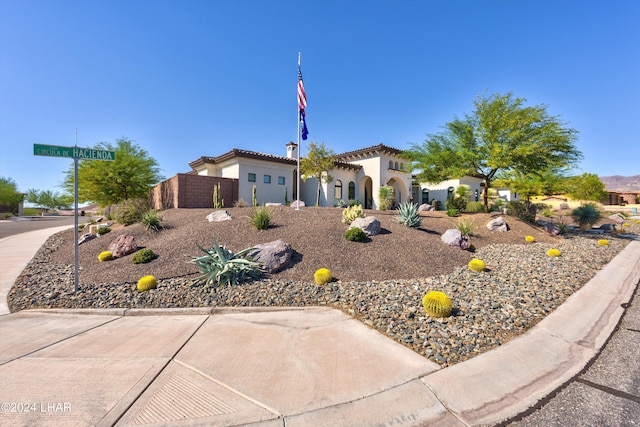 view of front of home with a tile roof and stucco siding