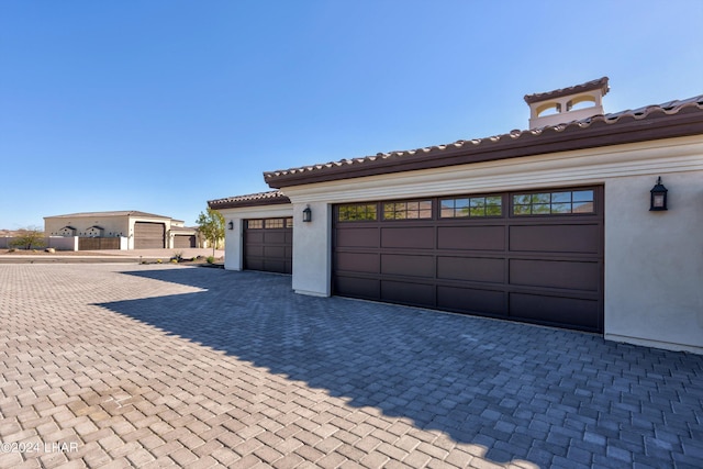 garage featuring decorative driveway