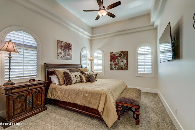 bedroom featuring carpet floors, multiple windows, a ceiling fan, and baseboards