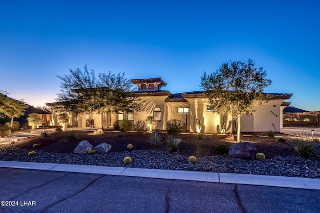 view of front of property featuring a tile roof and stucco siding