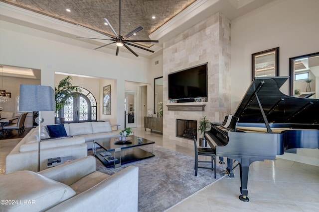 living area featuring recessed lighting, a large fireplace, ceiling fan, and a high ceiling