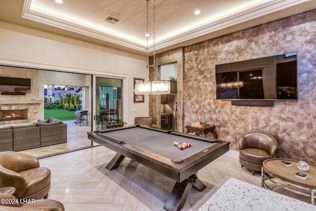 playroom with crown molding, a warm lit fireplace, visible vents, and billiards