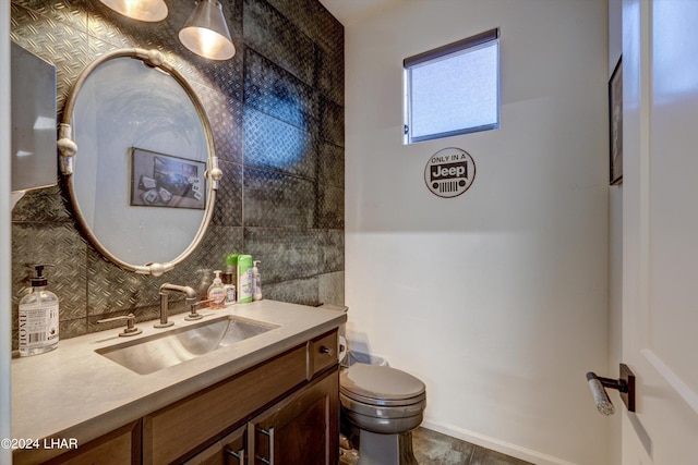 bathroom with tasteful backsplash, vanity, and toilet