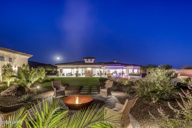 patio at night with an outdoor fire pit