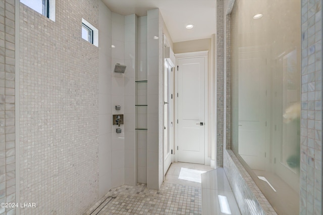 full bath with tile patterned flooring and a tile shower