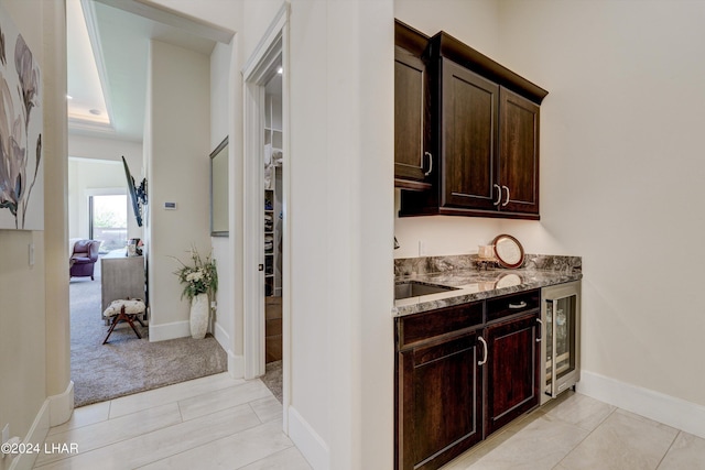 bar with wine cooler and baseboards