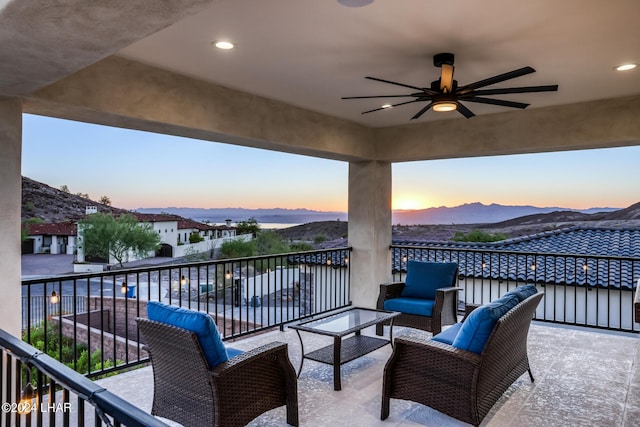 balcony with a mountain view, an outdoor hangout area, and ceiling fan