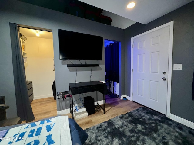 bedroom featuring baseboards and wood finished floors