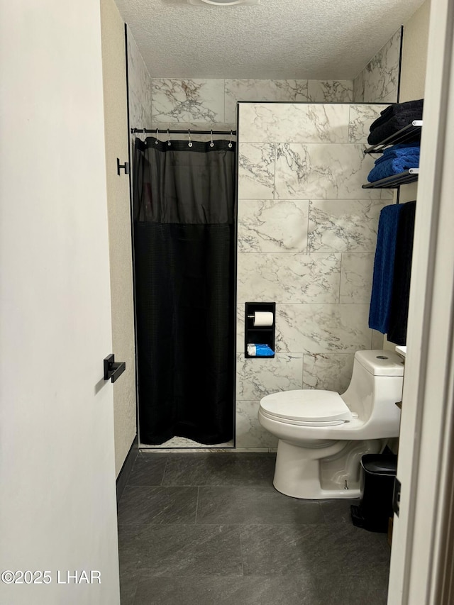 full bath featuring a stall shower, toilet, tile walls, and a textured ceiling