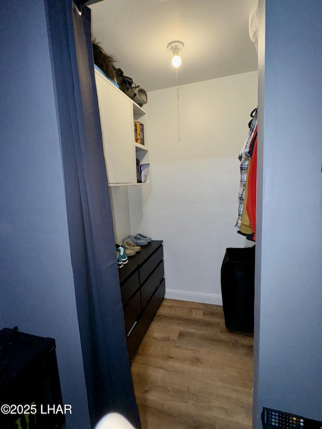 spacious closet with wood finished floors