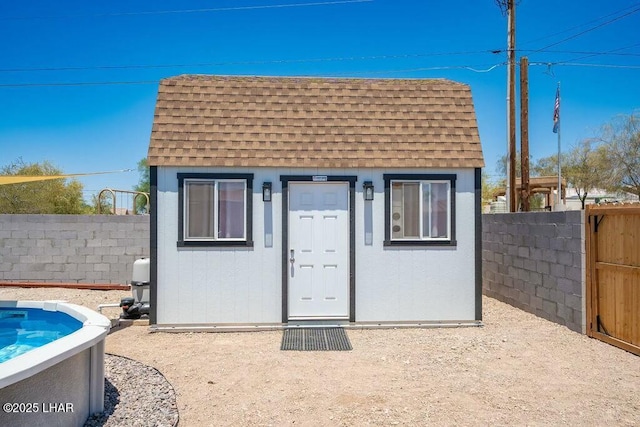 view of outbuilding with an outdoor structure and fence