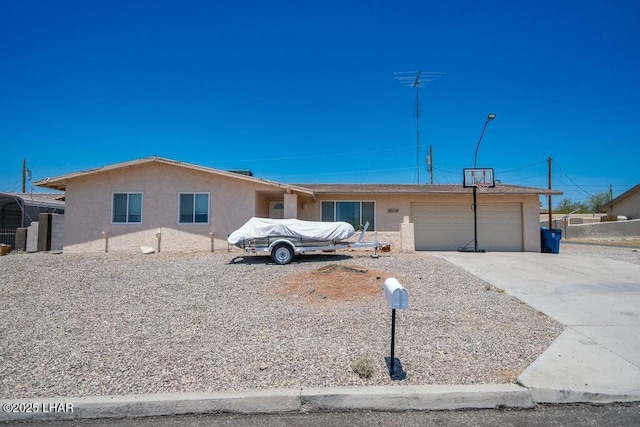 ranch-style house featuring stucco siding, a garage, and concrete driveway