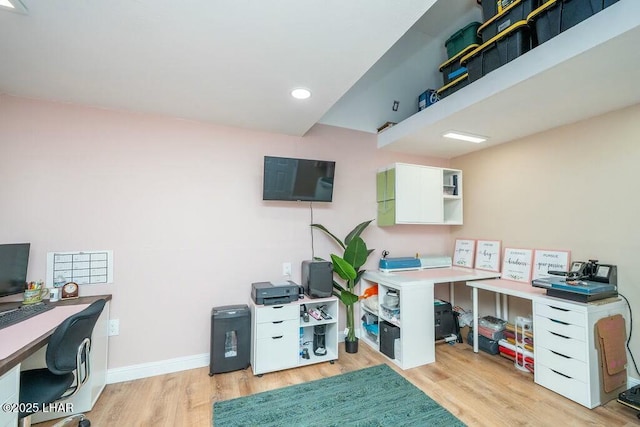 office space with recessed lighting, light wood-style flooring, and baseboards