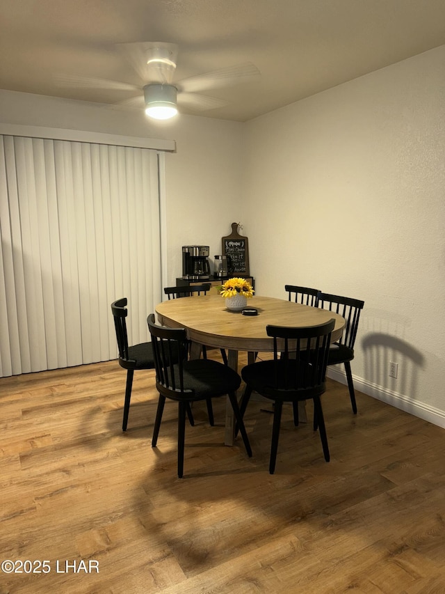 dining area featuring baseboards and wood finished floors